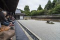 Visitors watching Ryoan-ji dry garden Kyoto Japan